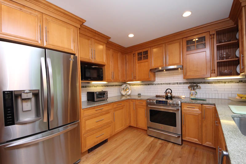 3 Miles Road Darien, CT 06820 - Photo 6 of 32 a kitchen with stainless steel appliances granite countertop a refrigerator a sink dishwasher a stove top oven a refrigerator with wooden cabinets and floor