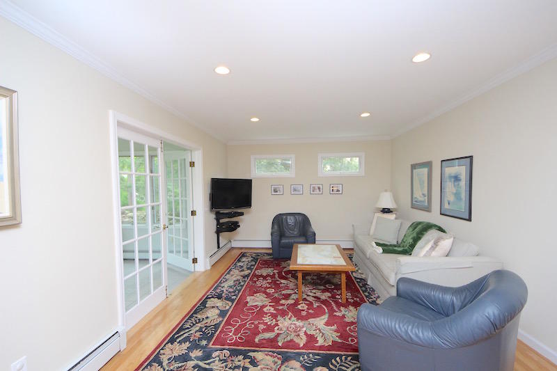 3 Miles Road Darien, CT 06820 - Photo 8 of 32 a living room with furniture and a flat screen tv
