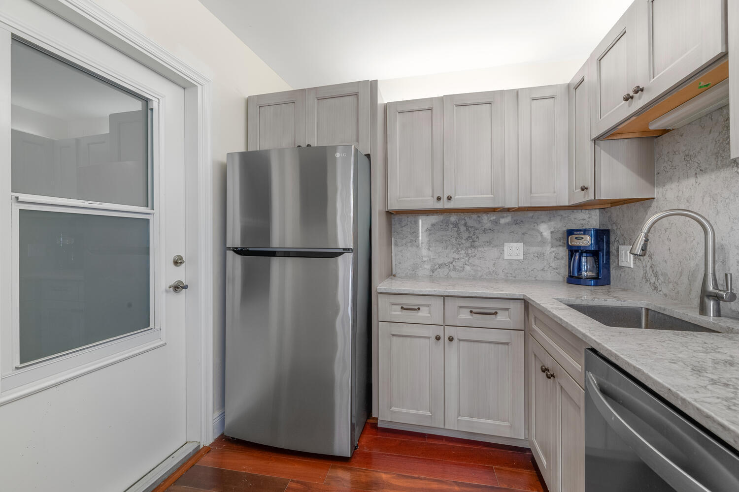 2780 South Ocean Boulevard, Unit 612 Palm Beach, FL 33480 - Photo 23 of 57 a kitchen with a refrigerator sink and cabinets