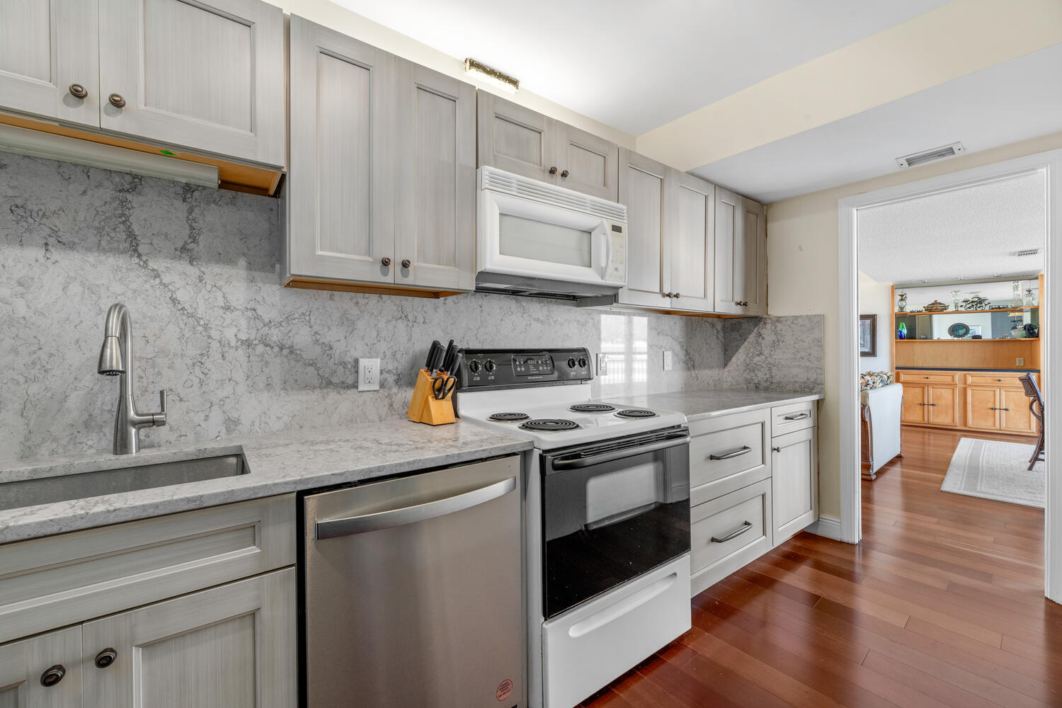 2780 South Ocean Boulevard, Unit 612 Palm Beach, FL 33480 - Photo 24 of 57 a kitchen with stainless steel appliances granite countertop a sink stove and cabinets