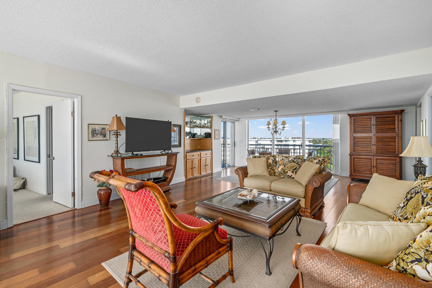 2780 South Ocean Boulevard, Unit 612 Palm Beach, FL 33480 - Photo 36 of 57 a living room with furniture a flat screen tv and kitchen view