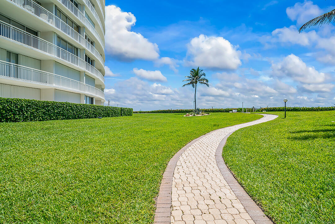 2780 South Ocean Boulevard, Unit 612 Palm Beach, FL 33480 - Photo 8 of 57 a view of a swimming pool with a garden