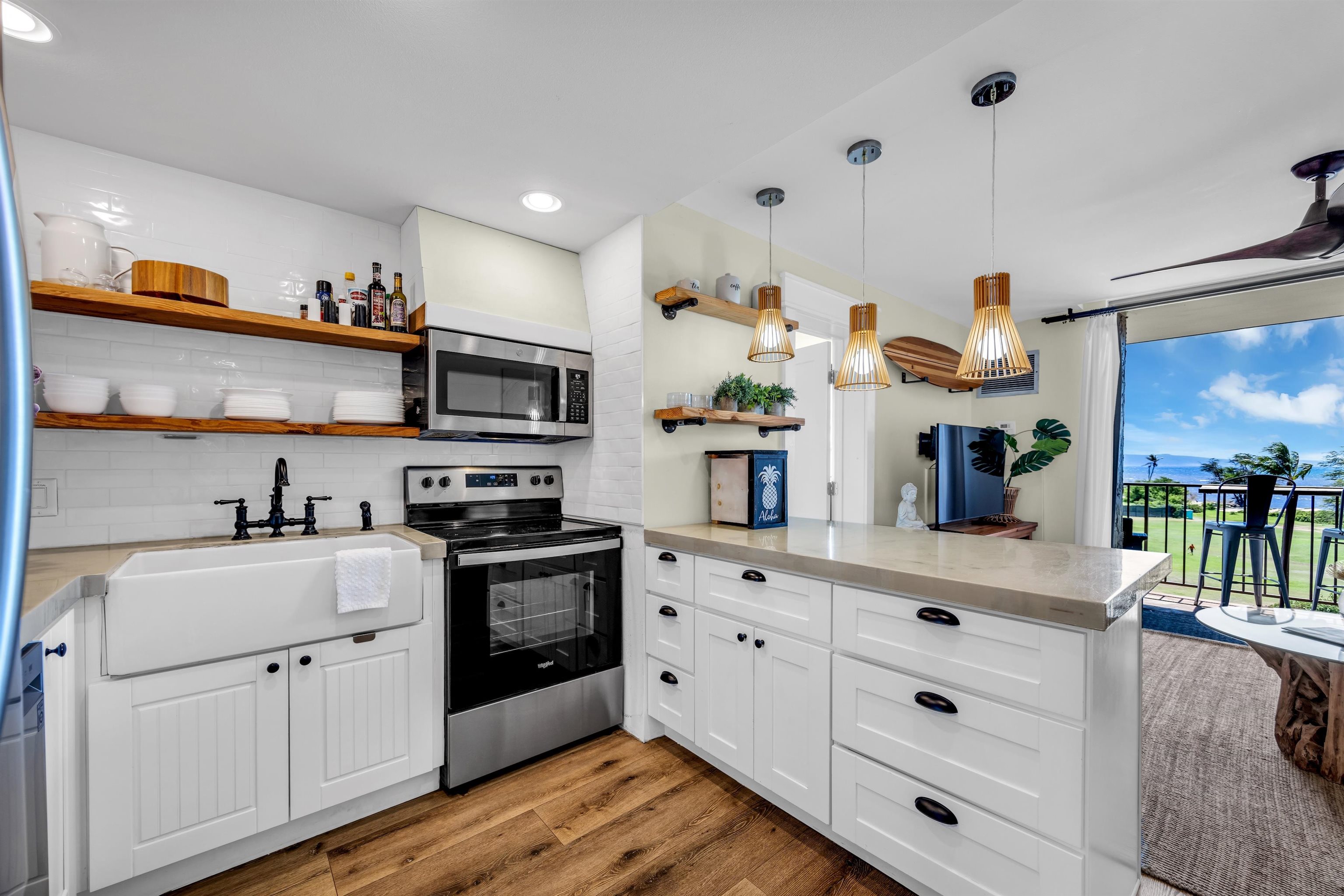 a kitchen with granite countertop white cabinets and appliances