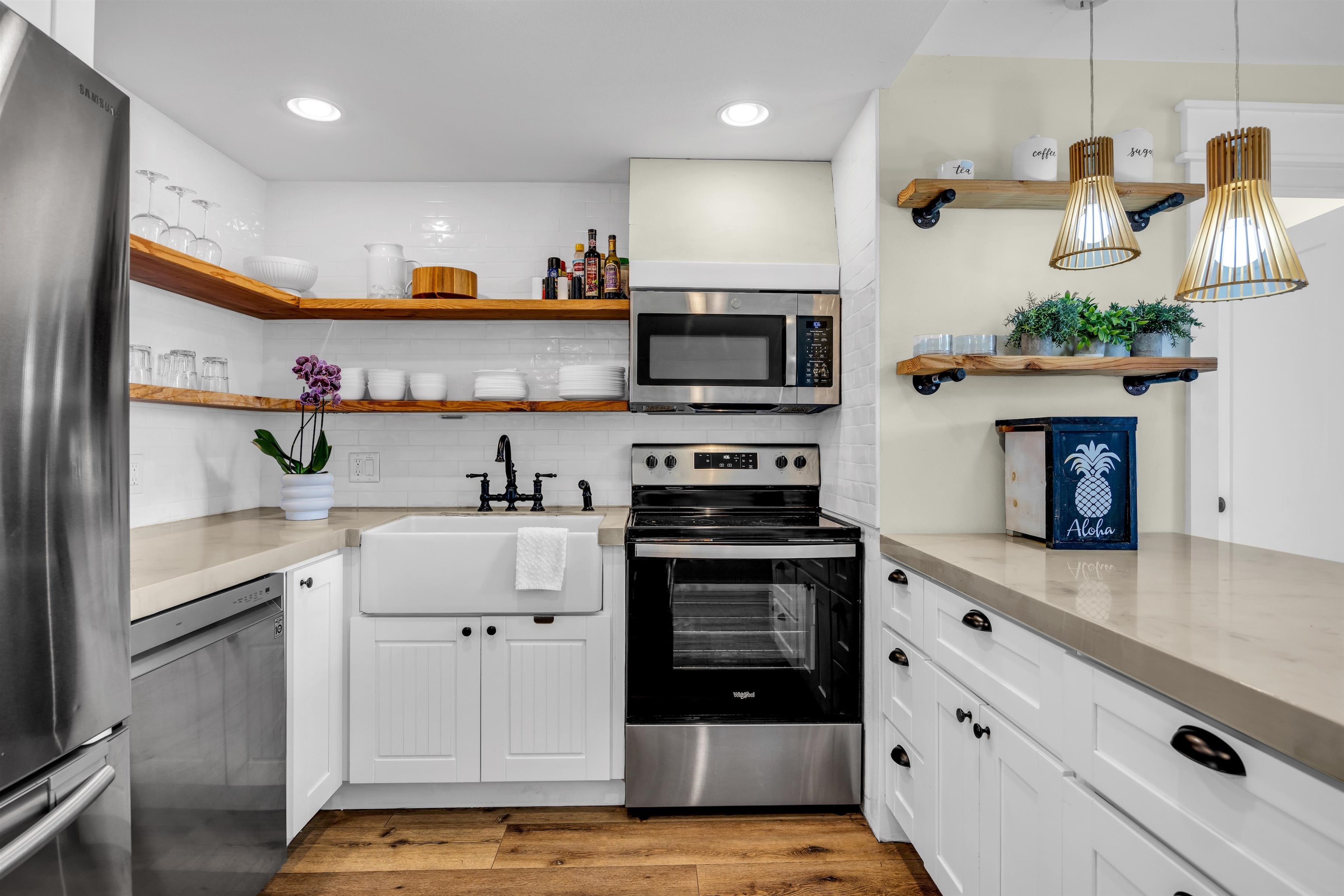 938 South Kihei Road, Unit 533 Kihei, HI 96753 - Photo 6 of 27 a kitchen with stainless steel appliances a stove microwave and cabinets
