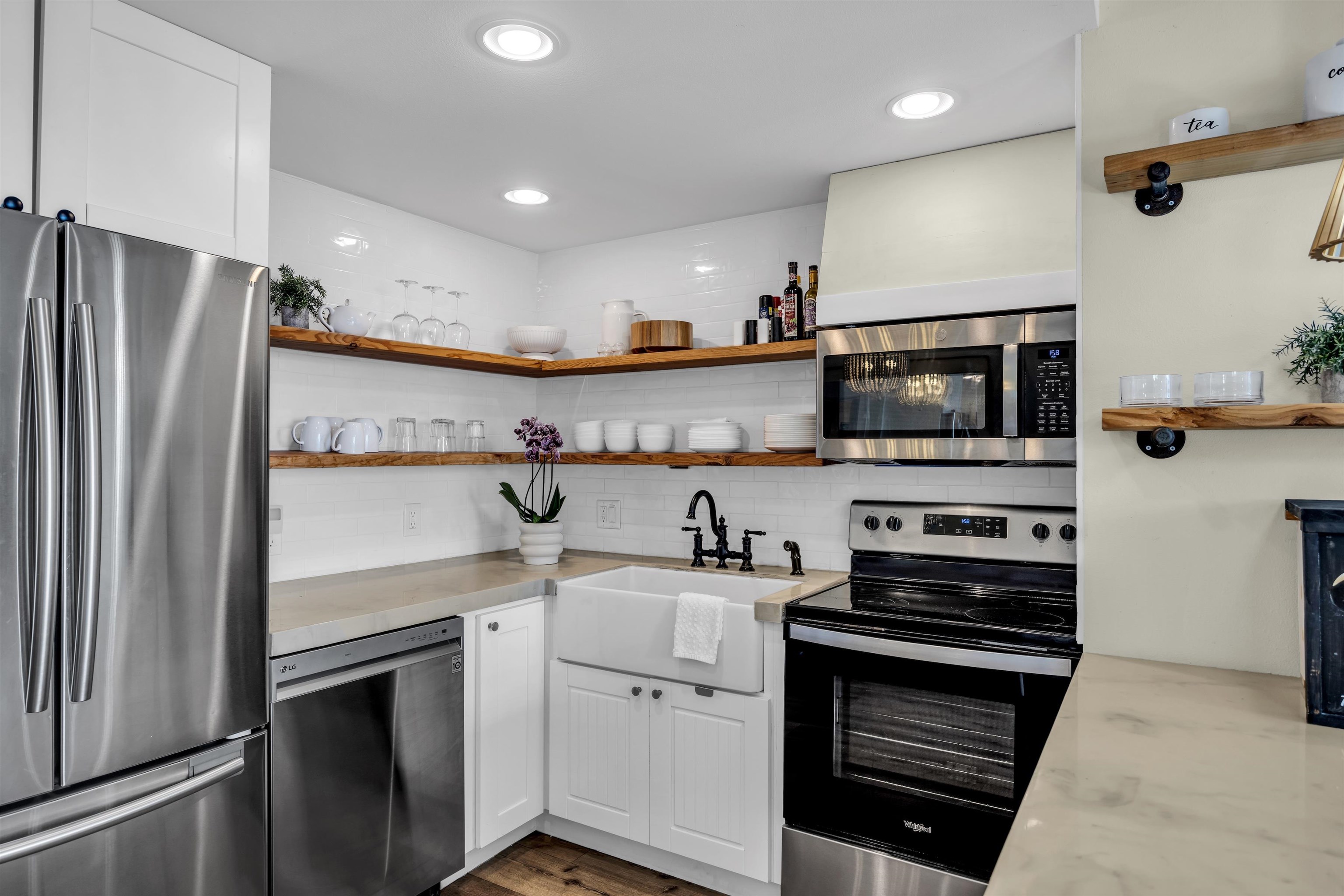 938 South Kihei Road, Unit 533 Kihei, HI 96753 - Photo 7 of 27 a kitchen with stainless steel appliances a stove microwave and a refrigerator