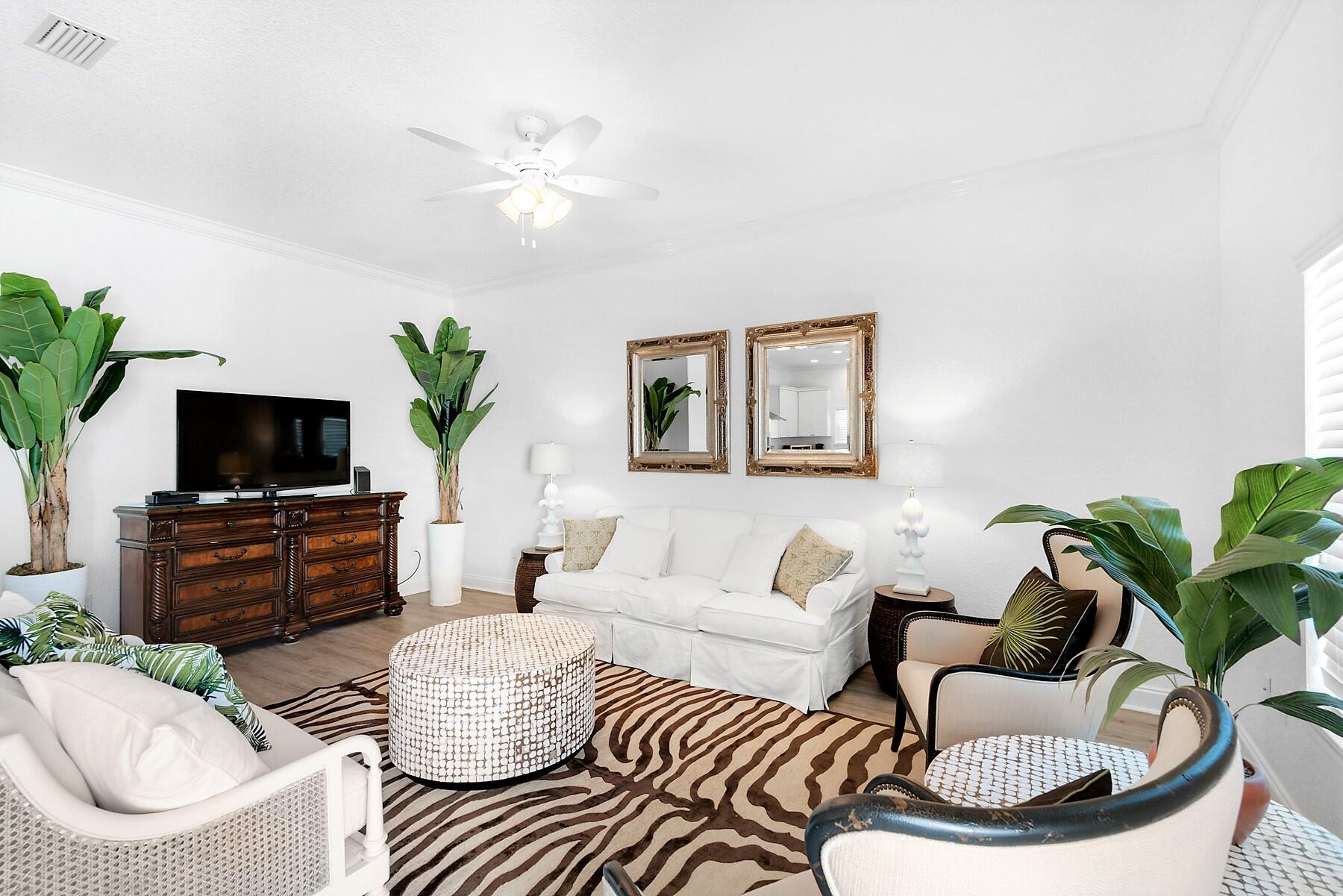 80 Pompano Street Destin, FL 32541 - Photo 13 of 71 a living room with furniture a flat screen tv and a potted plant