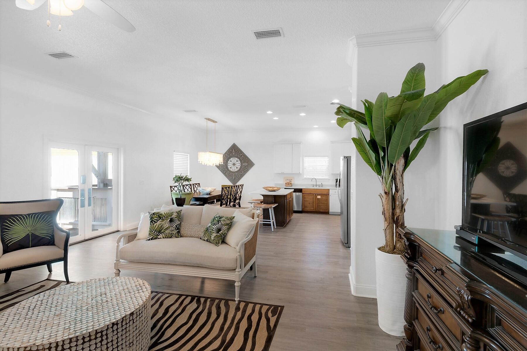 80 Pompano Street Destin, FL 32541 - Photo 15 of 71 a living room with furniture a potted plant and a bookshelf