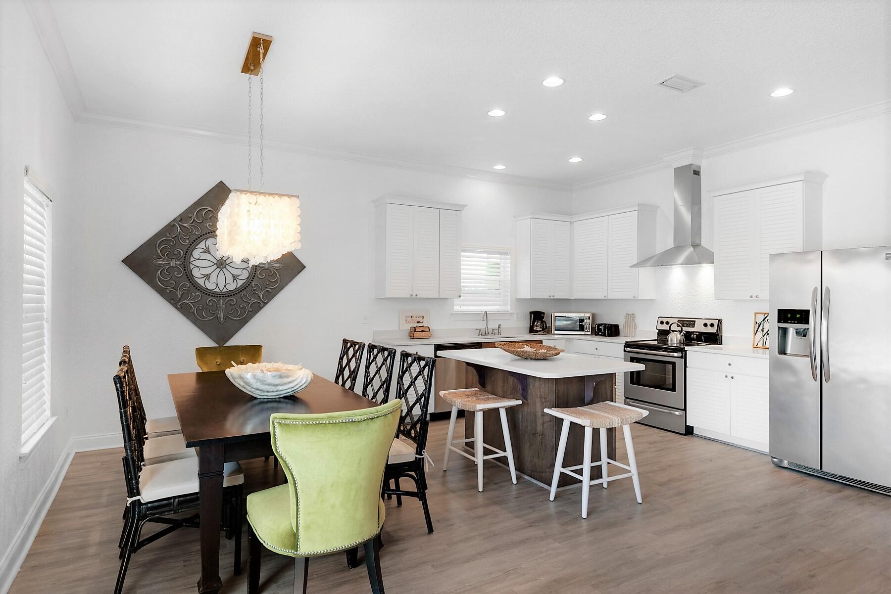 80 Pompano Street Destin, FL 32541 - Photo 17 of 71 a view of a dining room with furniture window and wooden floor