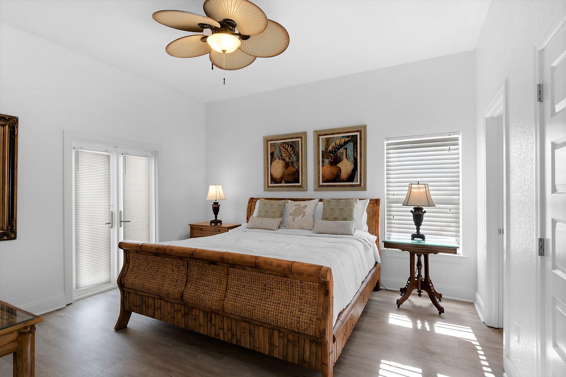 80 Pompano Street Destin, FL 32541 - Photo 21 of 71 a bedroom with a bed and wooden floor