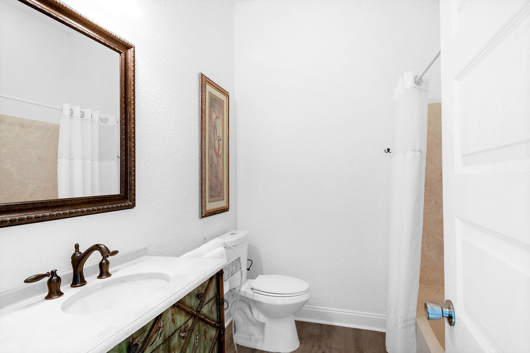 80 Pompano Street Destin, FL 32541 - Photo 23 of 71 a bathroom with a sink a toilet and mirror