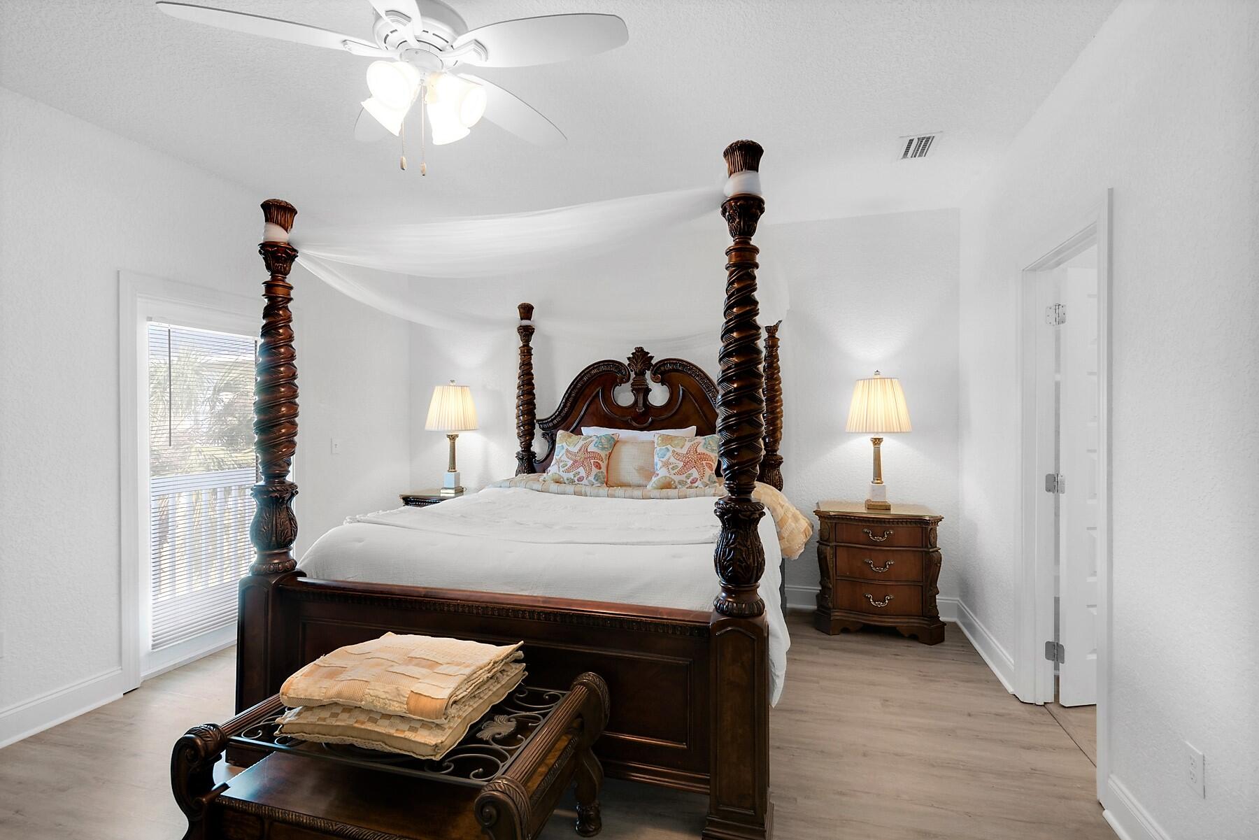 80 Pompano Street Destin, FL 32541 - Photo 28 of 71 a bedroom with a bed and a chandelier