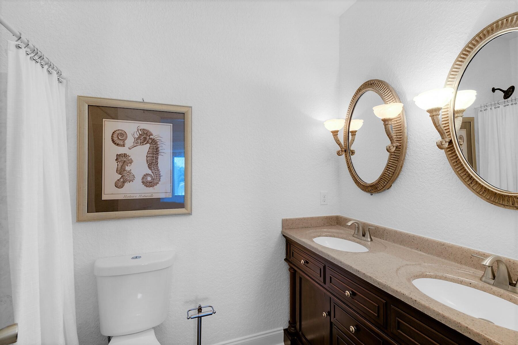 80 Pompano Street Destin, FL 32541 - Photo 30 of 71 a bathroom with a sink and a mirror