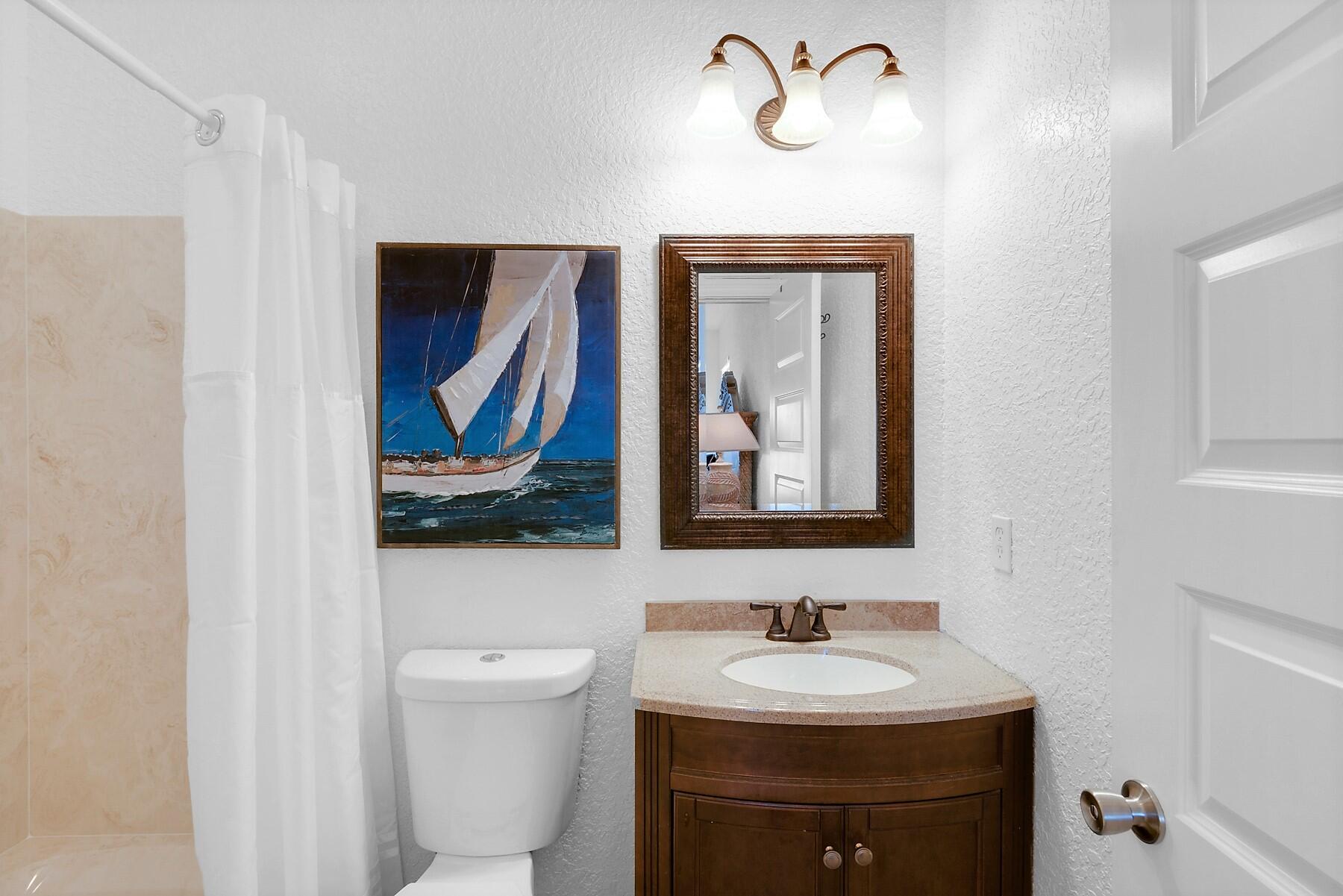 80 Pompano Street Destin, FL 32541 - Photo 34 of 71 a bathroom with a sink and a mirror