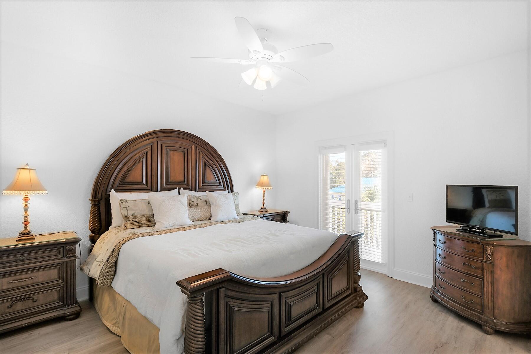 80 Pompano Street Destin, FL 32541 - Photo 36 of 71 a bedroom with a bed and a flat screen tv