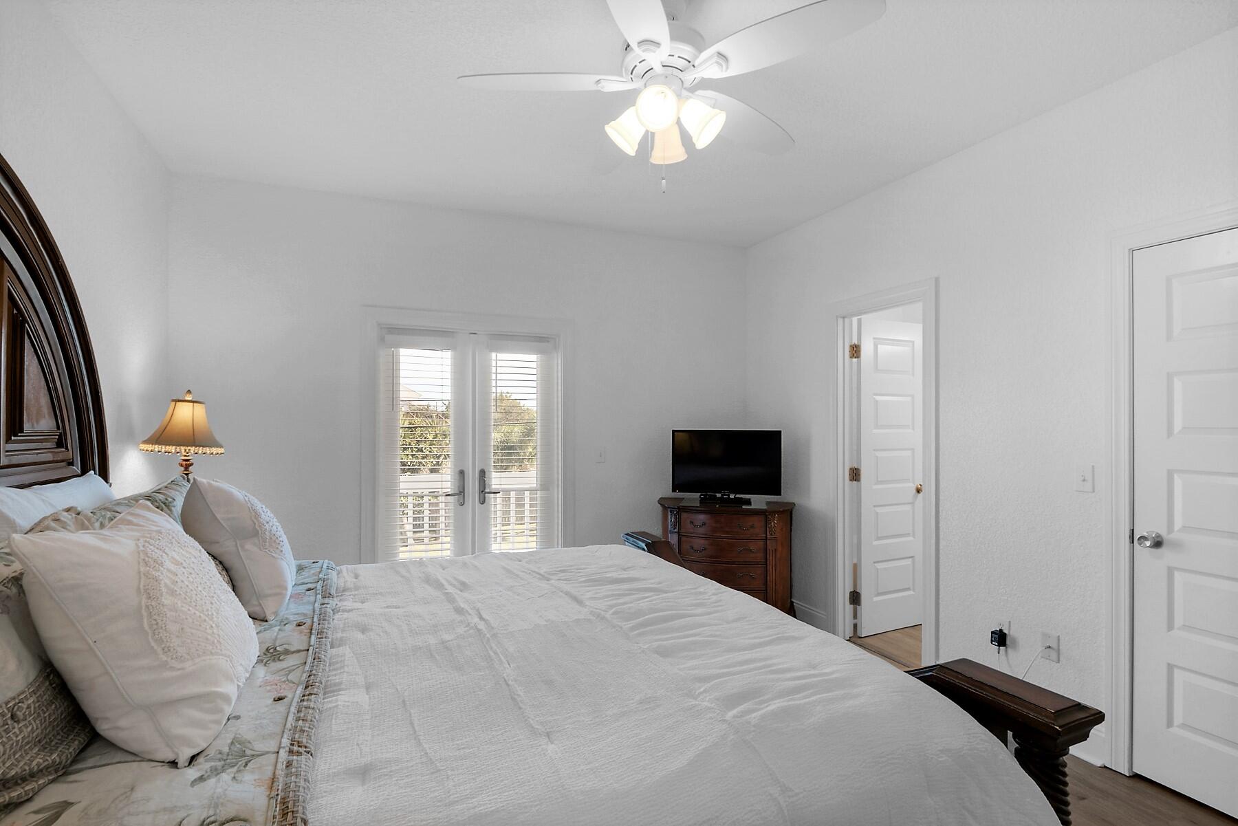 80 Pompano Street Destin, FL 32541 - Photo 37 of 71 a bedroom with a bed and a flat tv screen on the dresser