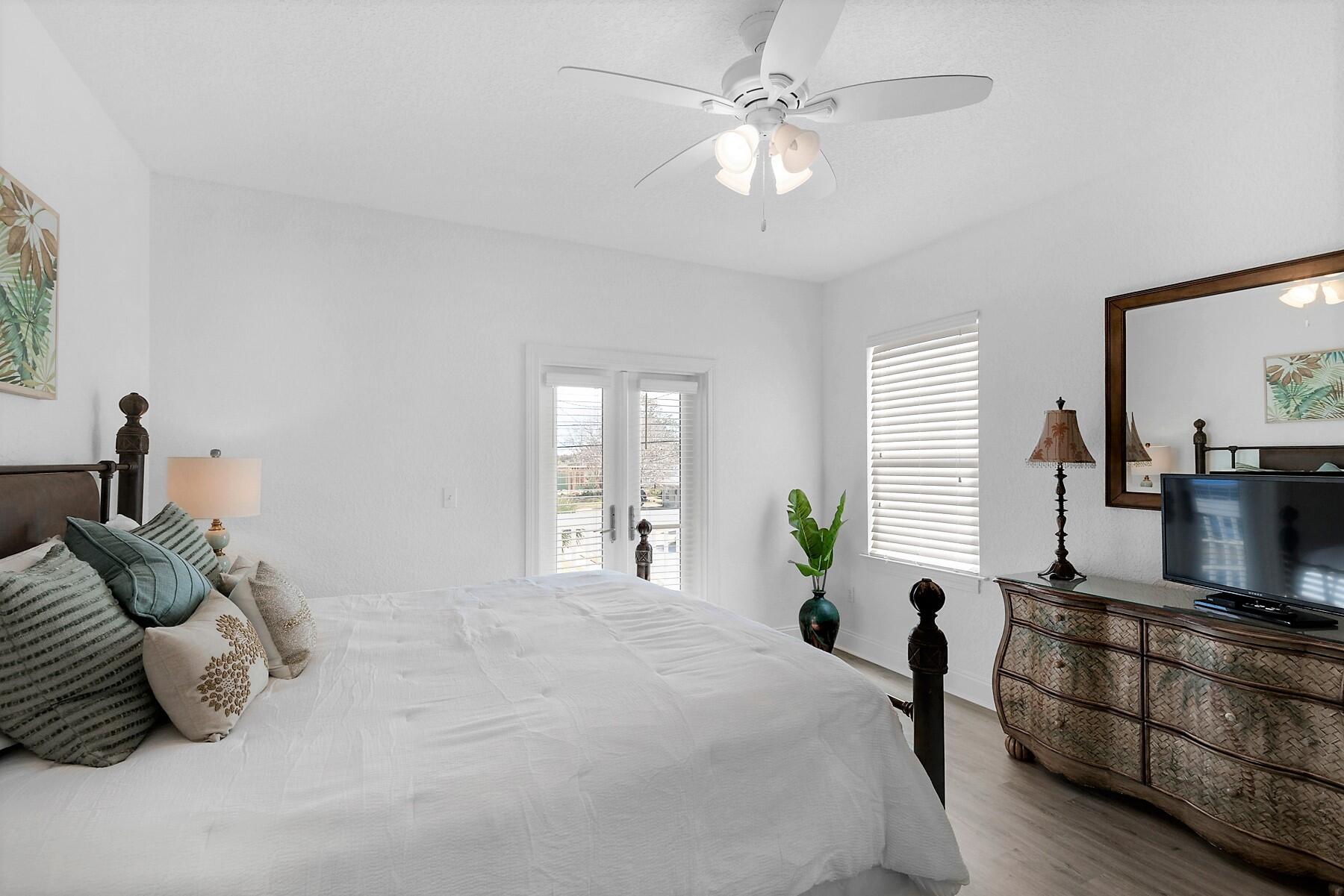 80 Pompano Street Destin, FL 32541 - Photo 41 of 71 a bedroom with a large bed and windows