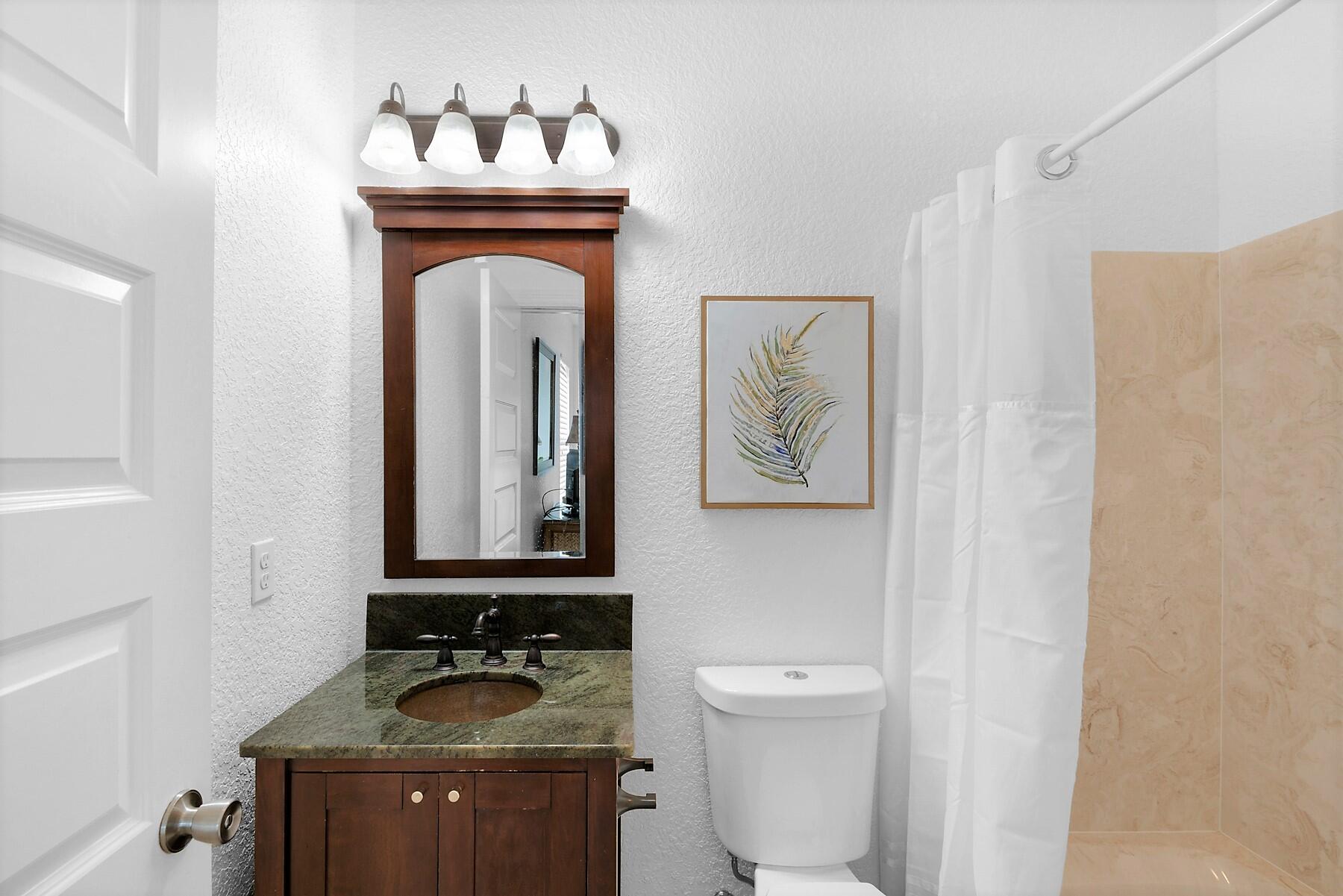 80 Pompano Street Destin, FL 32541 - Photo 42 of 71 a bathroom with a toilet sink and mirror