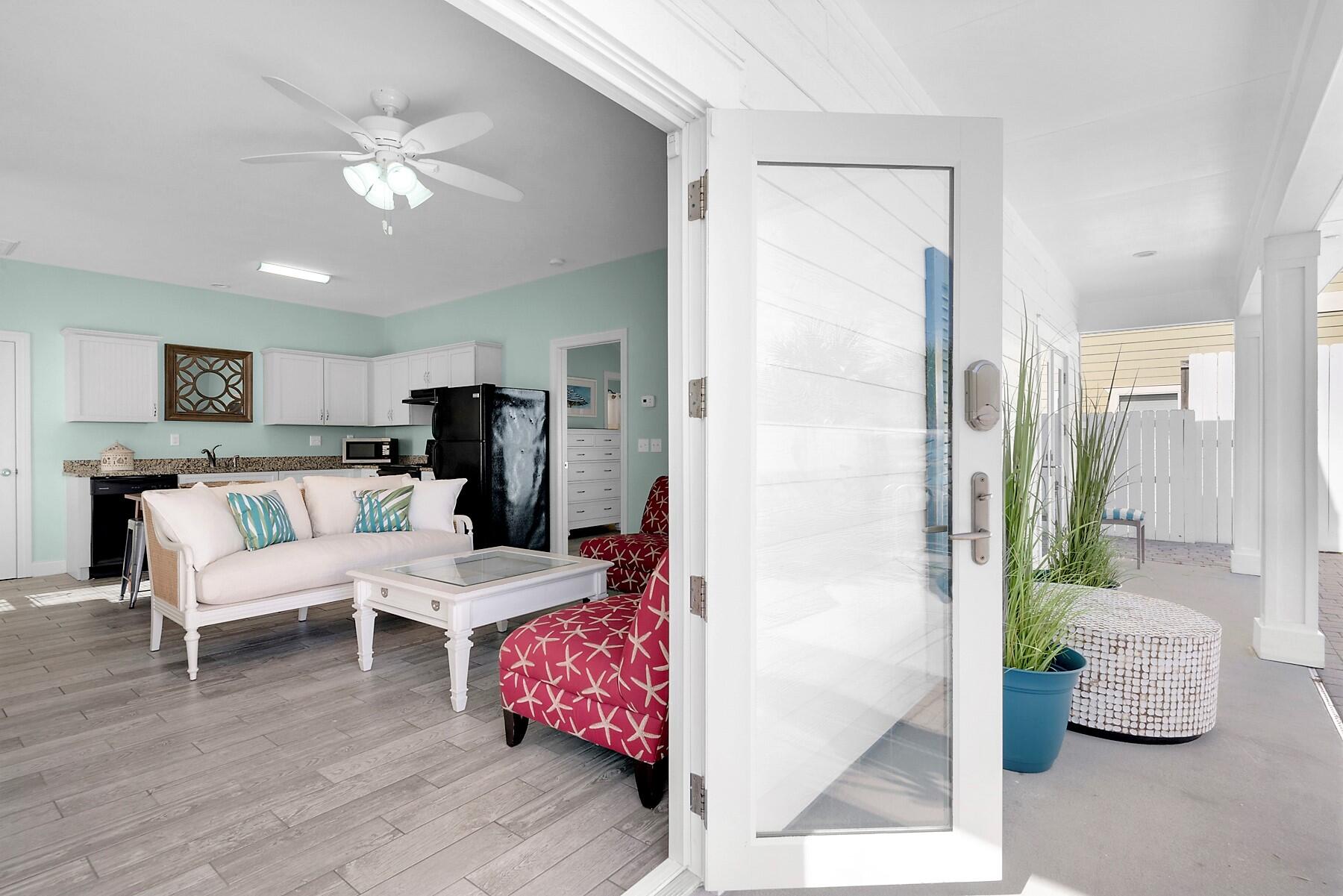 80 Pompano Street Destin, FL 32541 - Photo 45 of 71 a living room with furniture and a chandelier
