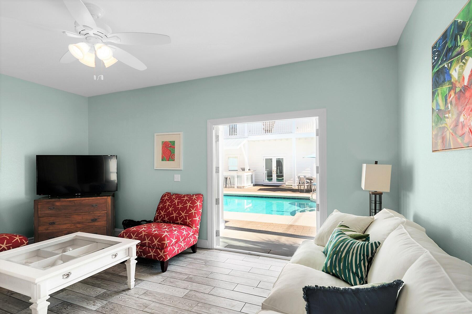 80 Pompano Street Destin, FL 32541 - Photo 46 of 71 a living room with furniture and a flat screen tv