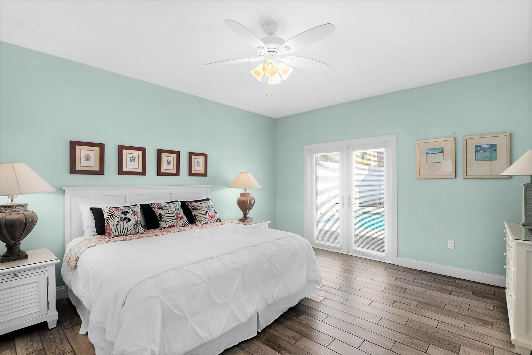 80 Pompano Street Destin, FL 32541 - Photo 50 of 71 a bedroom with two beds and a chandelier
