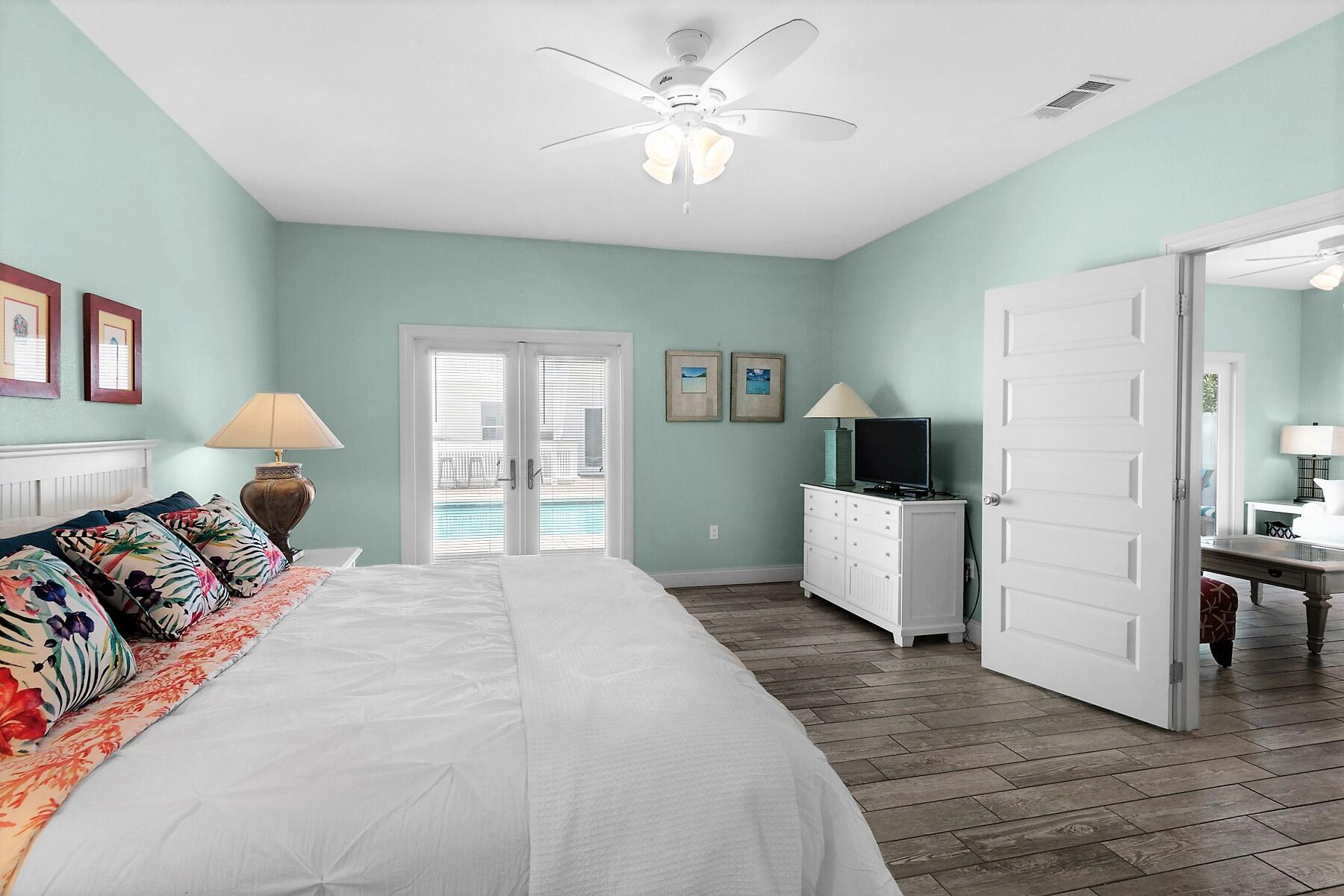 80 Pompano Street Destin, FL 32541 - Photo 51 of 71 a bedroom with a bed and a chandelier