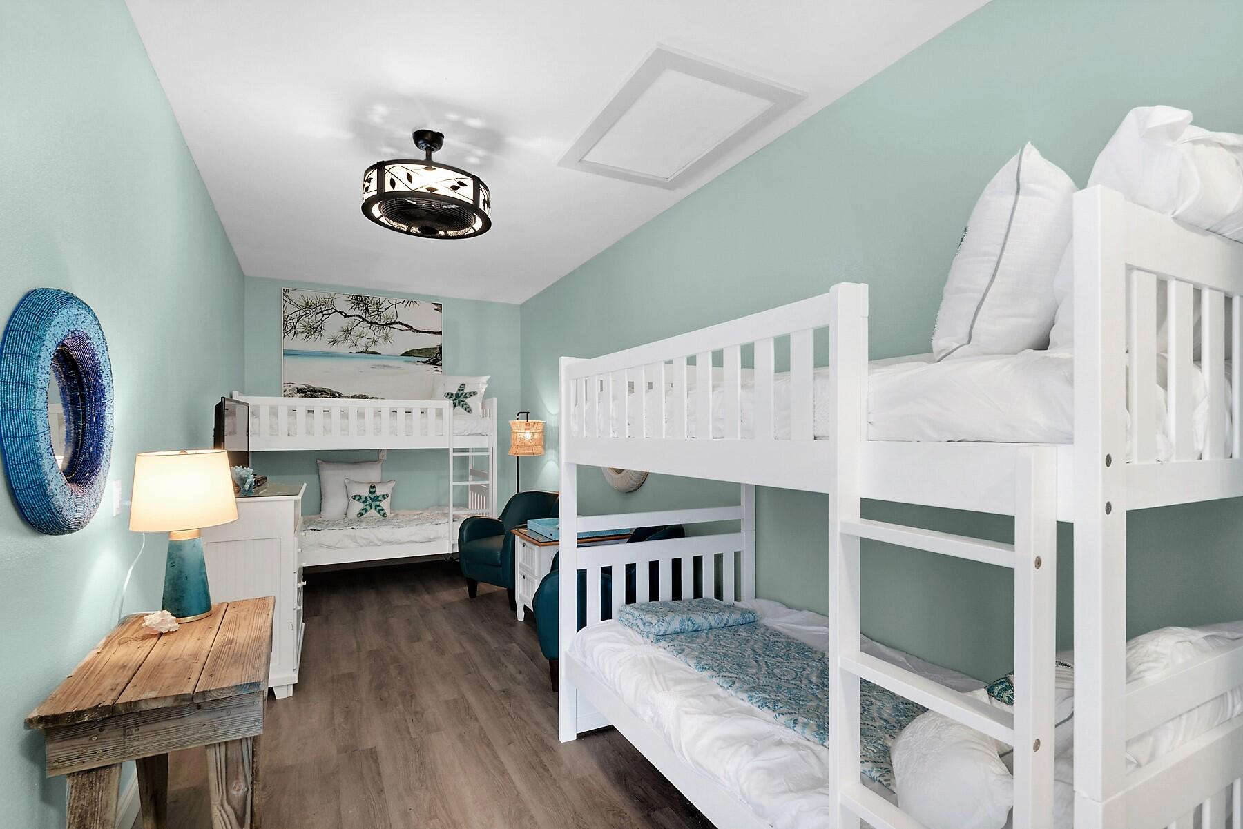 80 Pompano Street Destin, FL 32541 - Photo 54 of 71 a bedroom with furniture and a wooden floor