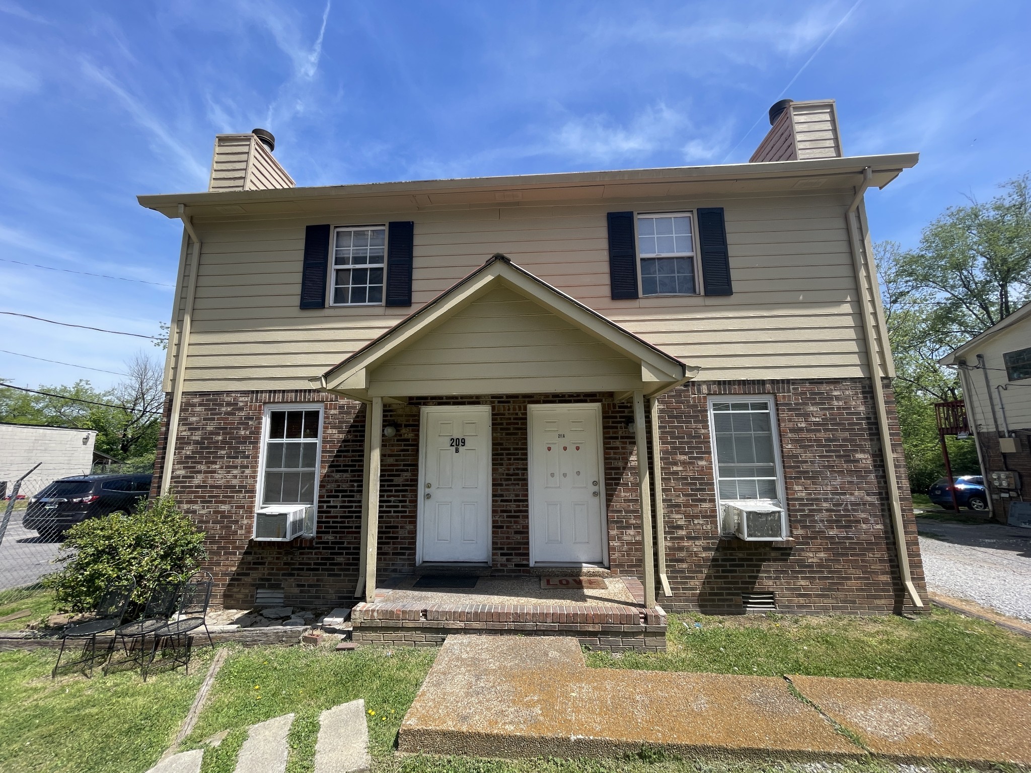 209 East Webster Street Madison, TN 37115 - Photo 1 of 33 a front view of a house with garden