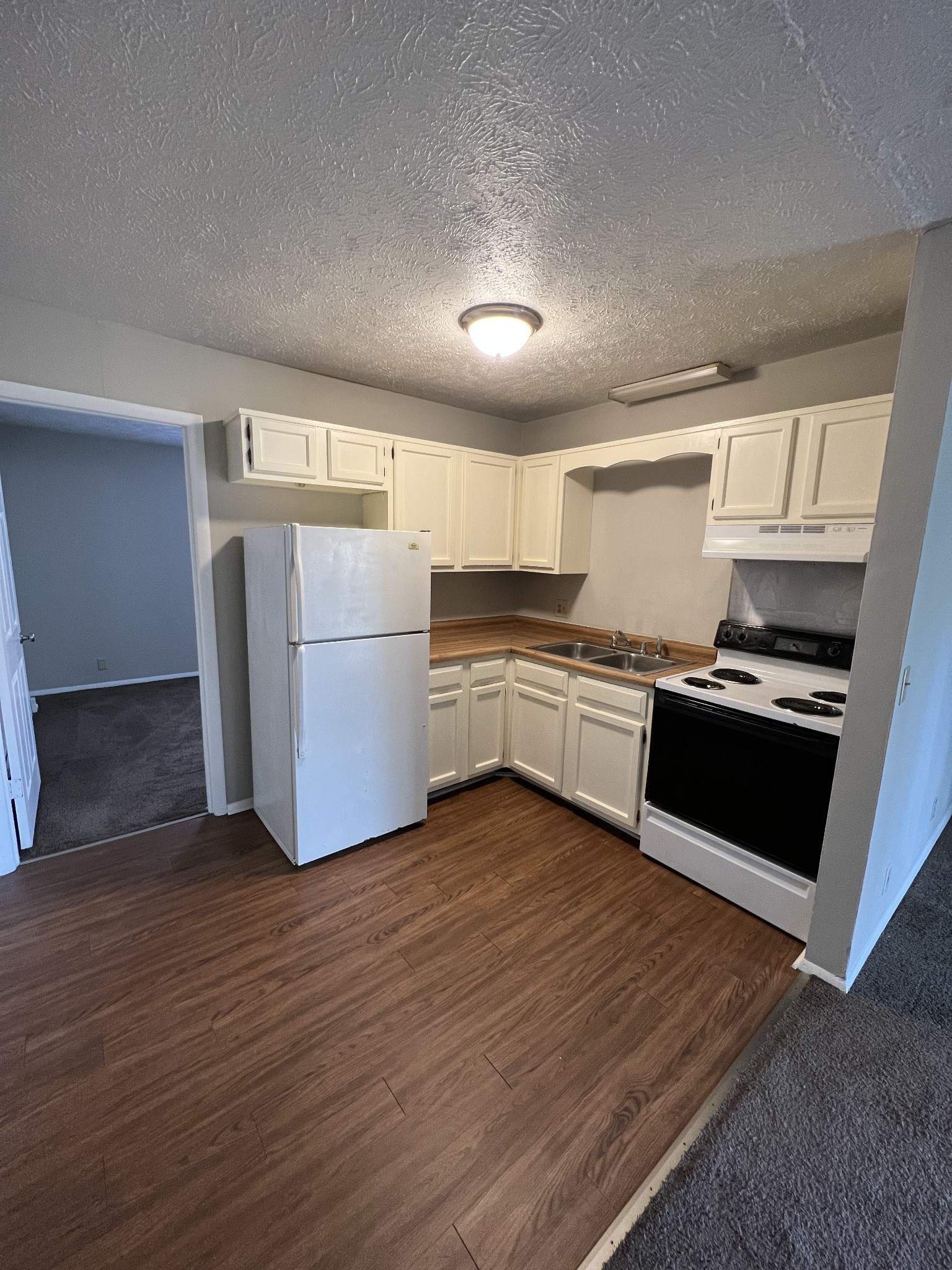 209 East Webster Street Madison, TN 37115 - Photo 16 of 33 a kitchen with a refrigerator and a stove top oven