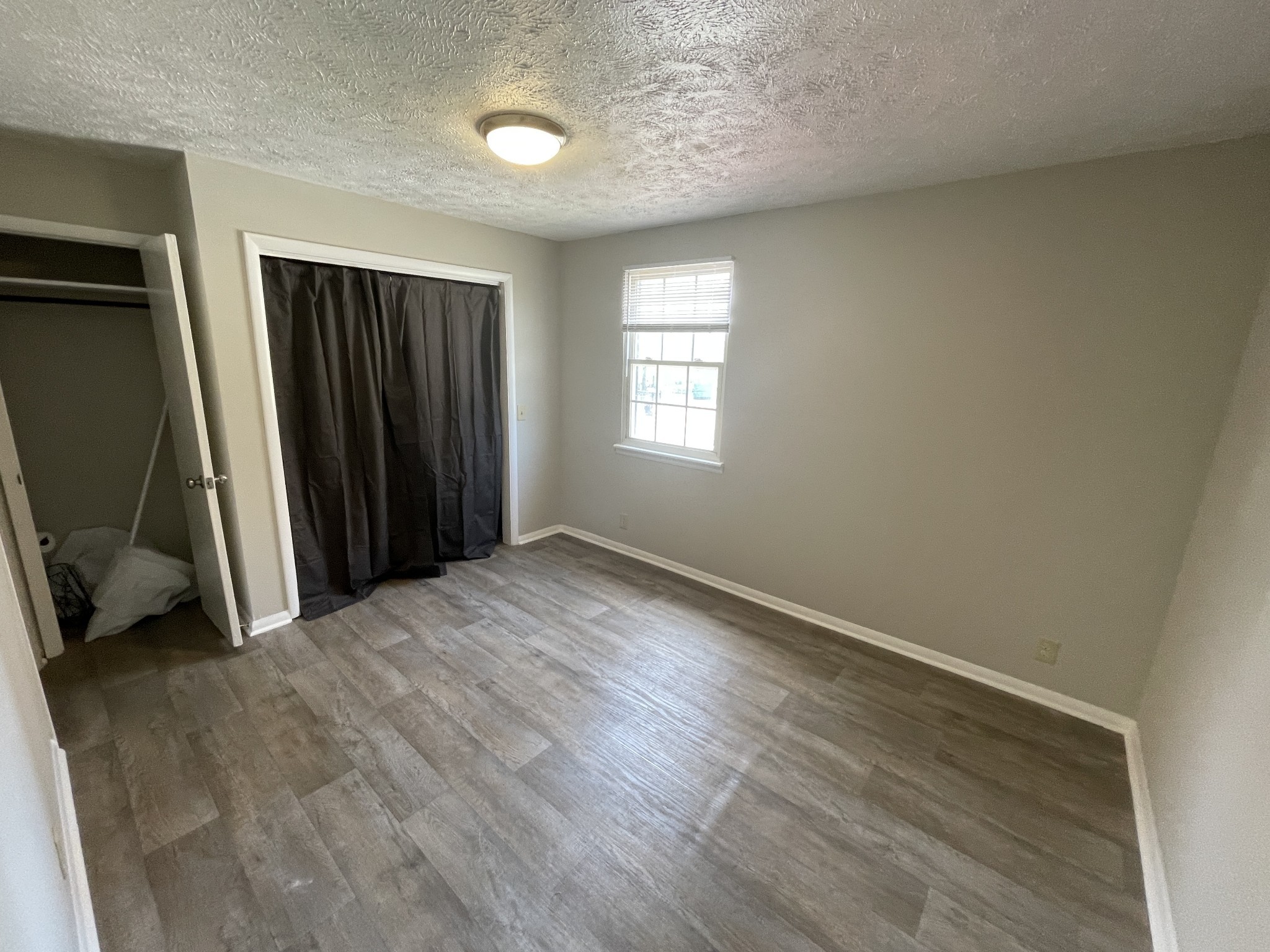 209 East Webster Street Madison, TN 37115 - Photo 4 of 33 wooden floor in an empty room with a window