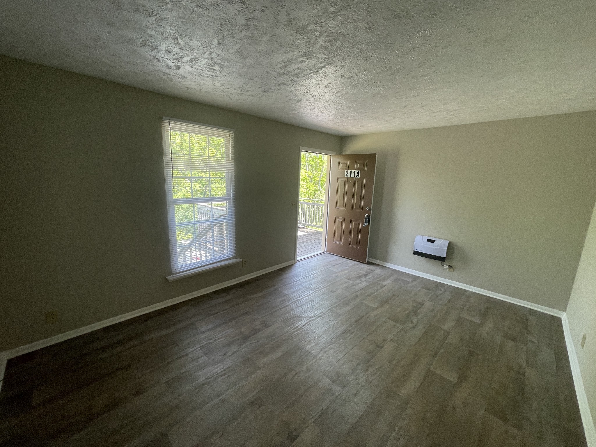 209 East Webster Street Madison, TN 37115 - Photo 6 of 33 an empty room with wooden floor and windows