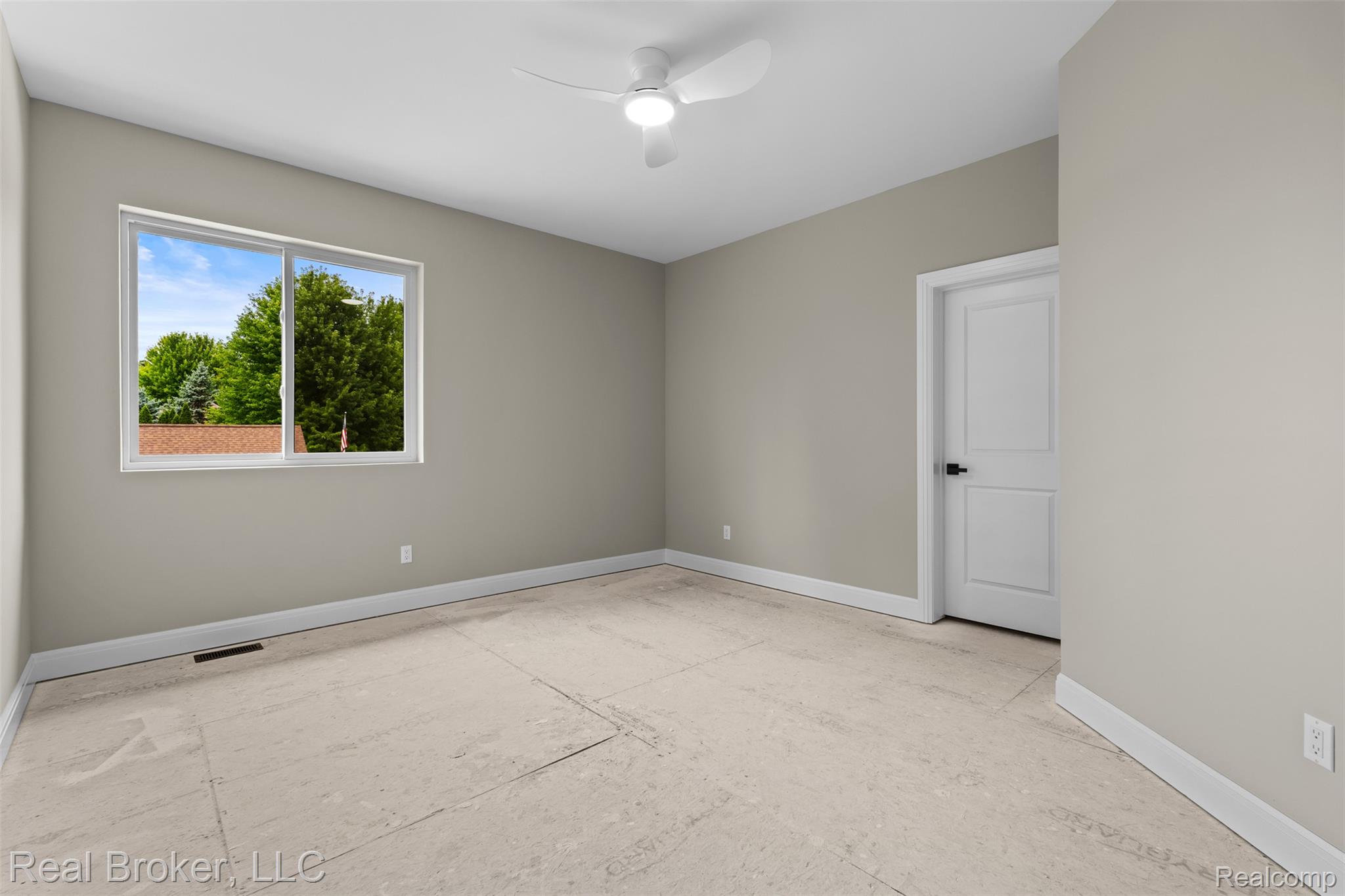 12114 22 Mile Road Utica, MI 48315 - Photo 48 of 70 Neutral wall paint, white trim, modern ceiling fan, large window, paneled interior door with dark hardware