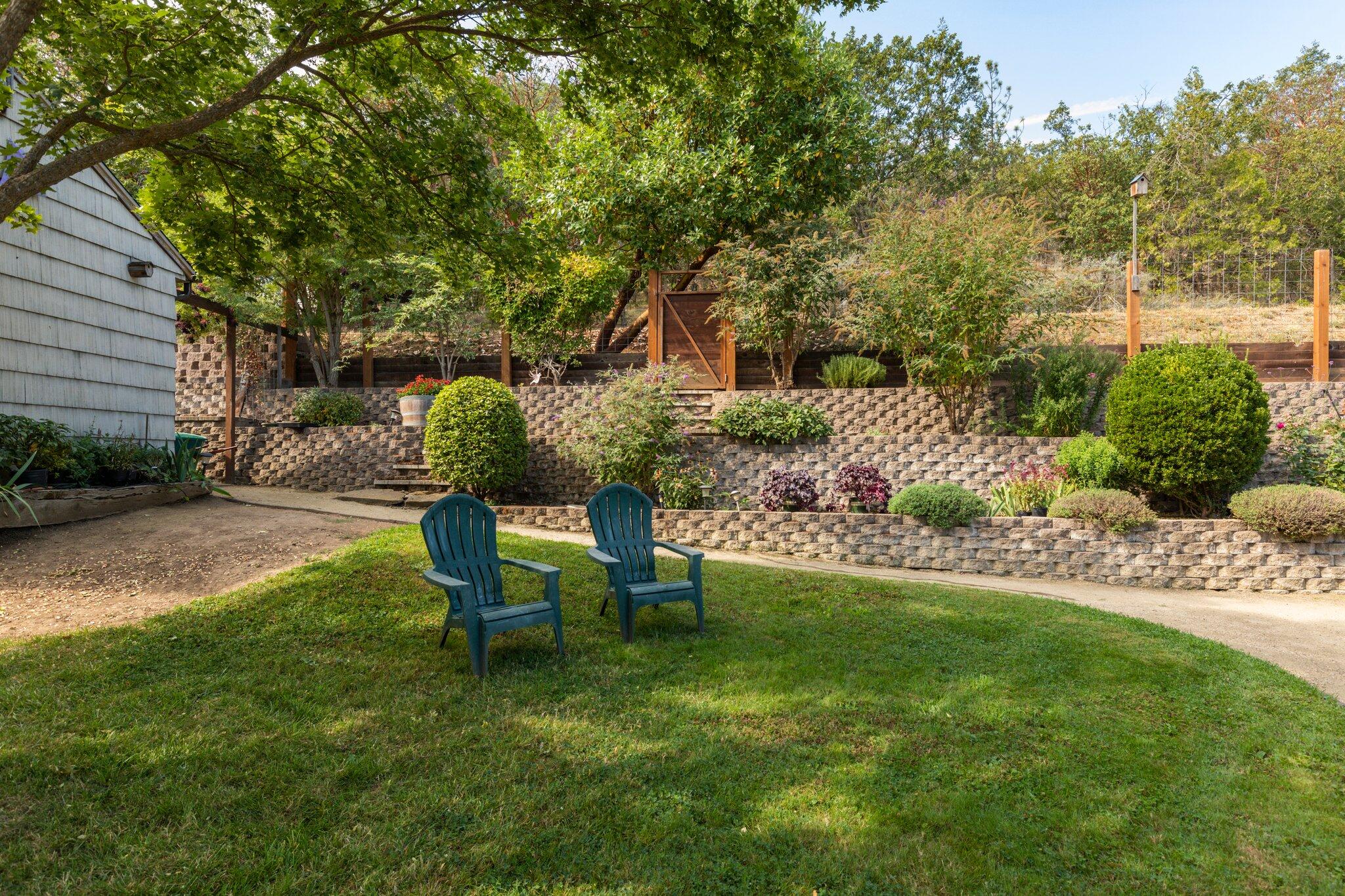 6062 Adams Road Talent, OR 97540 - Photo 35 of 75 a view of a backyard with couches plants and large tree