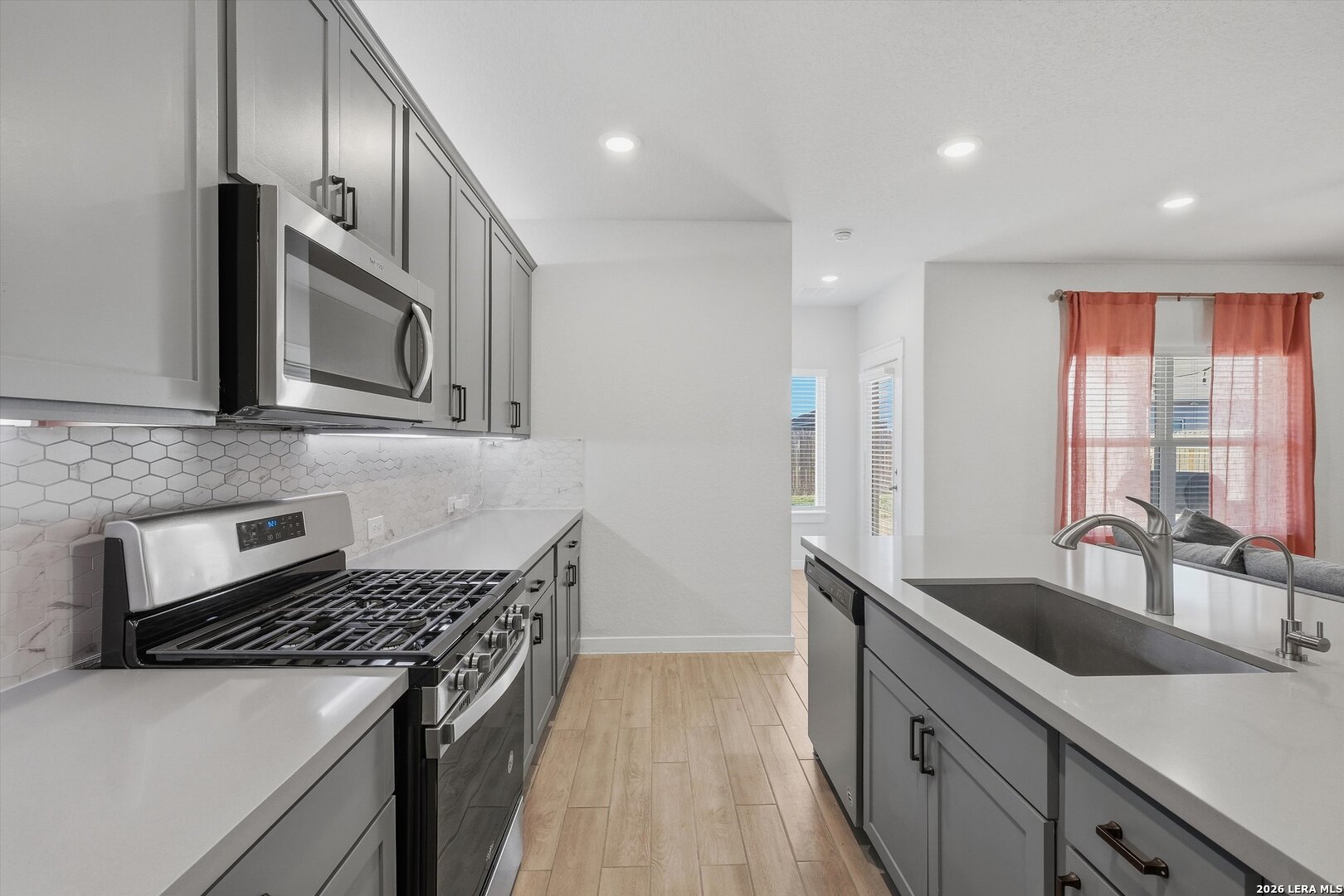 10776 Rosalina Loop Converse, TX 78109 - Photo 11 of 31 a kitchen with stainless steel appliances granite countertop a sink stove and refrigerator