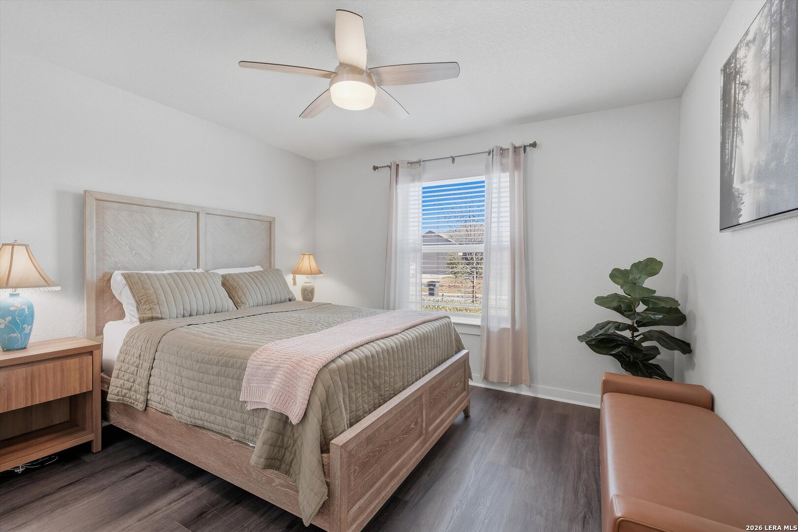 10776 Rosalina Loop Converse, TX 78109 - Photo 15 of 31 a bedroom with a bed and a potted plant