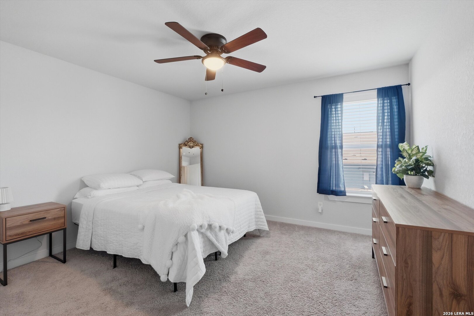 10776 Rosalina Loop Converse, TX 78109 - Photo 19 of 31 a spacious bedroom with a bed and a table in it