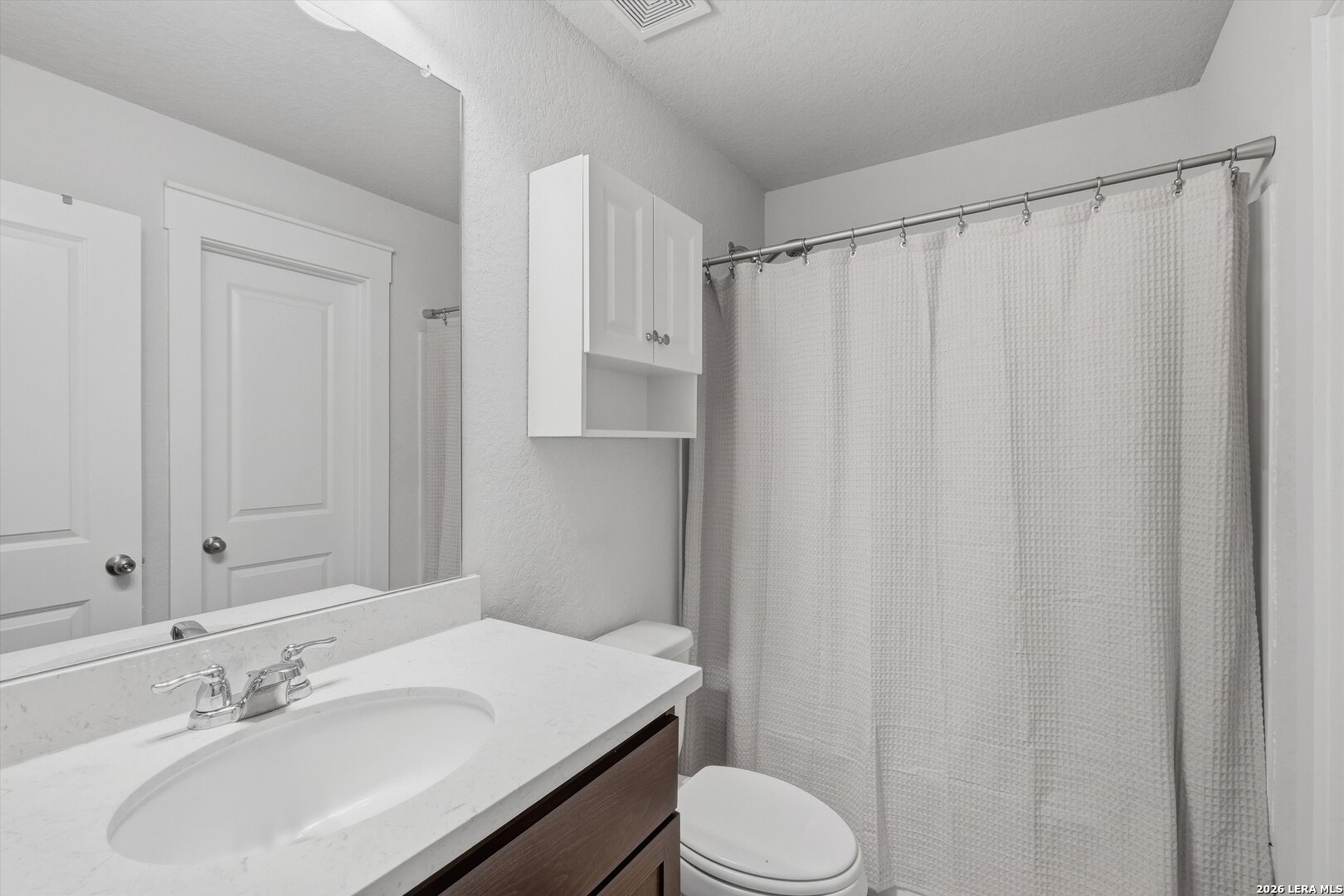 10776 Rosalina Loop Converse, TX 78109 - Photo 24 of 31 a bathroom with a sink a toilet and shower curtain