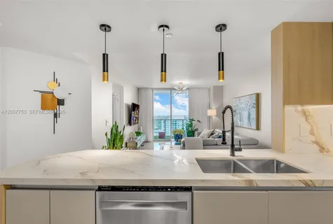 a kitchen with kitchen island a sink stainless steel appliances and a counter top
