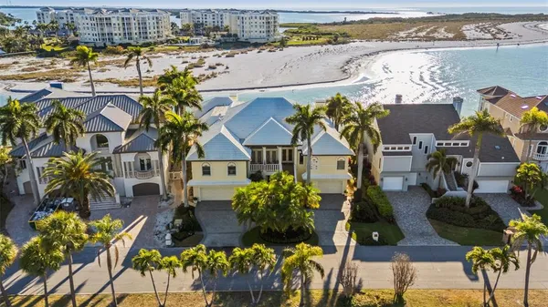 an aerial view of residential houses with outdoor space and parking