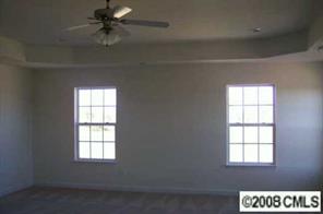 2023 Ruben Road Monroe, NC 28112 - Photo 6 of 8 an empty room with windows and fan