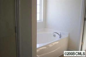 2023 Ruben Road Monroe, NC 28112 - Photo 7 of 8 a bathroom with a bathtub