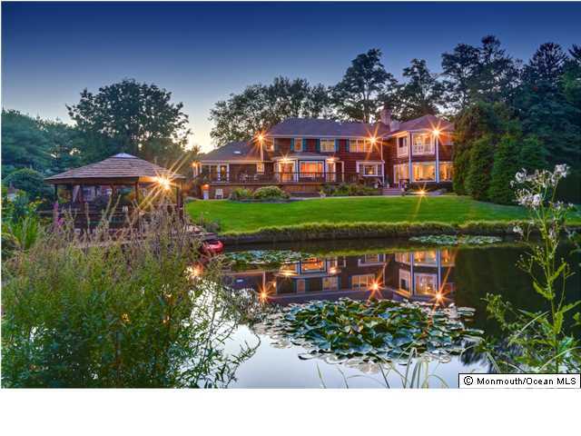 11 Pirates Cove Road Little Silver, NJ 07739 - Photo 14 of 14 a view of a house with a yard and a pond