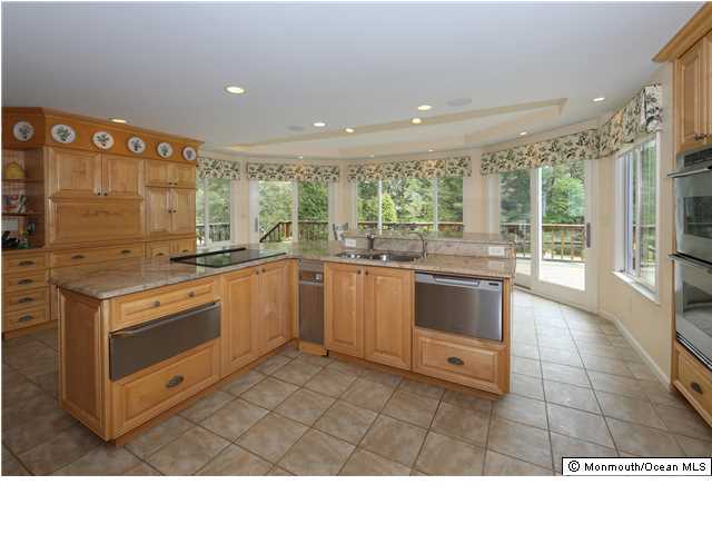 11 Pirates Cove Road Little Silver, NJ 07739 - Photo 4 of 14 a kitchen with a stove sink and cabinets