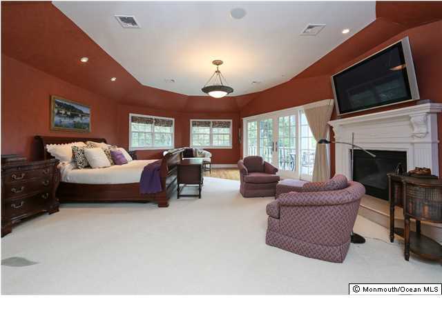 11 Pirates Cove Road Little Silver, NJ 07739 - Photo 7 of 14 a living room with furniture a fireplace and a flat screen tv
