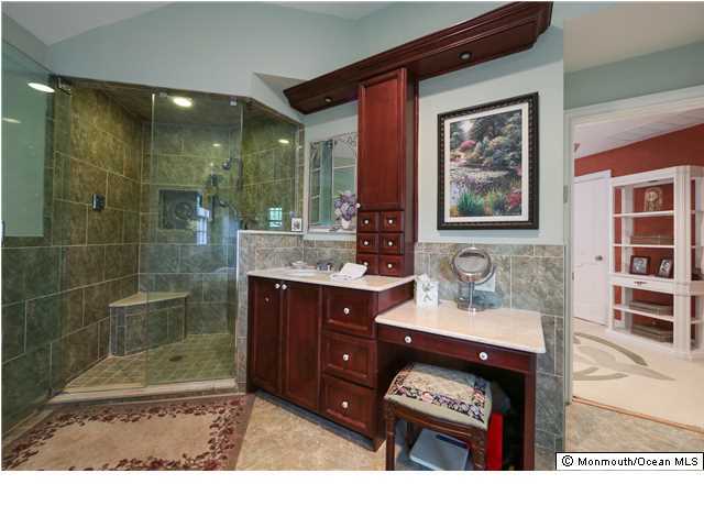 11 Pirates Cove Road Little Silver, NJ 07739 - Photo 8 of 14 a bathroom with a sink a mirror and a shower