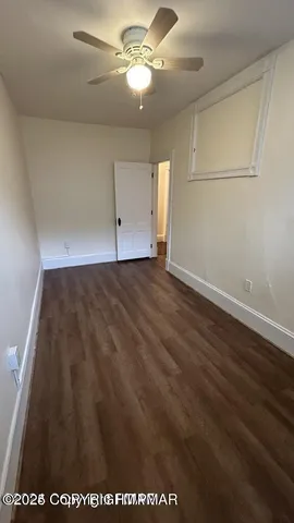 a view of kitchen and empty room