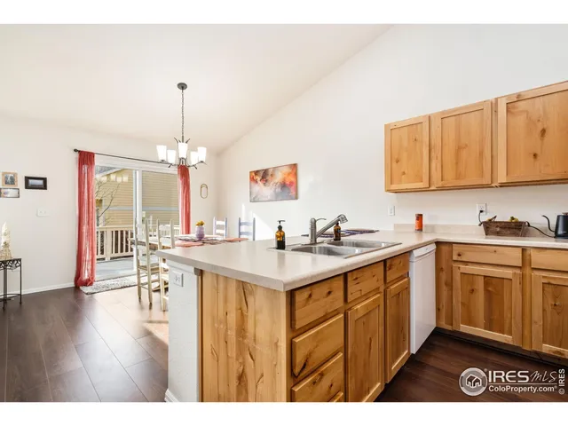 a kitchen with a sink cabinets and wooden floor
