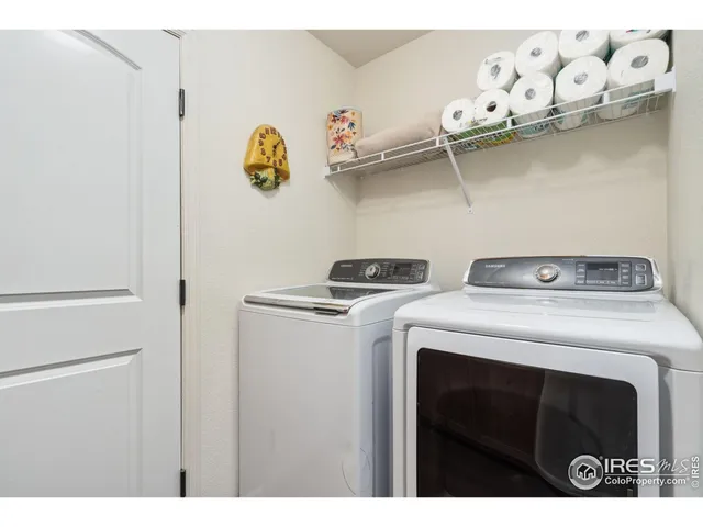 a utility room with dryer and cabinets