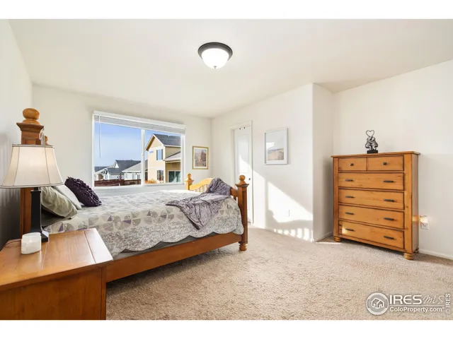 a bedroom with a bed and dresser