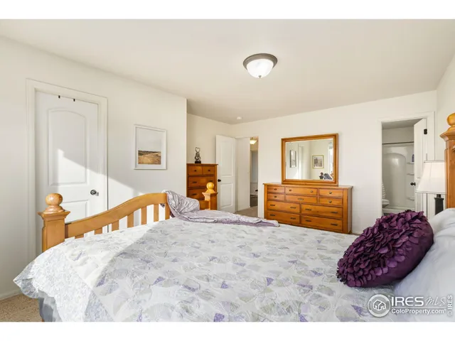 a bedroom with a bed and a dresser in it