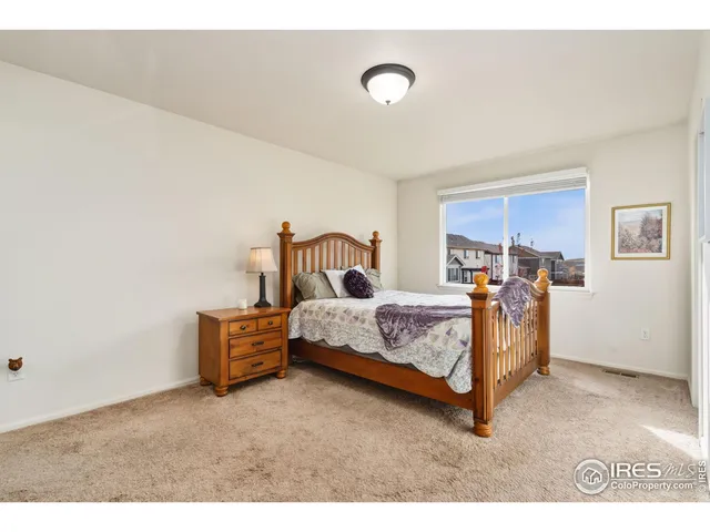 a bed room with a bed and window